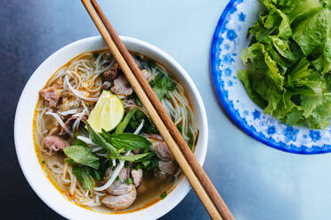 https://us.images.westend61.de/0001325141j/high-angle-close-up-of-a-bowl-of-bun-bo-hue-or-beef-noodle-soup-MINF13357.jpg
